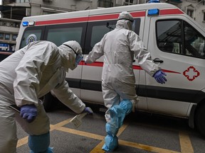 An ambulance medical staff sprays disinfectant on his colleague after arriving at Wuhan Red Cross Hospital.
Beijing dismissed as "ridiculous" a Harvard Medical School study of hospital traffic and search engine data that suggested the new coronavirus may already have been spreading in China last August, and scientists said it offered no convincing evidence of when the outbreak began.

The research, which has not been peer-reviewed by other scientists, used satellite imagery of hospital parking lots in Wuhan -- where the disease was first identified in late 2019 -- and data for symptom-related queries on search engines for things such as "cough" and "diarrhea."