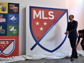 In this file photo taken on September 18, 2014 Major League Soccer (MLS) commissioner Don Garber unveils the MLS logo during an event in New York on September.