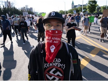 Protesters march in Detroit, Michigan on May 31, 2020 following a night of protests that saw several arrests and uses of tear gas by the Detroit Police department on what was peaceful protesting. - Thousands of National Guard troops patrolled major US cities after five consecutive nights of protests over racism and police brutality that boiled over into arson and looting, sending shock waves through the country. The death Monday of an unarmed black man, George Floyd, at the hands of police in Minneapolis ignited this latest wave of outrage in the US over law enforcement's repeated use of lethal force against African Americans -- this one like others before captured on cellphone video. (Photo by SETH HERALD / AFP)