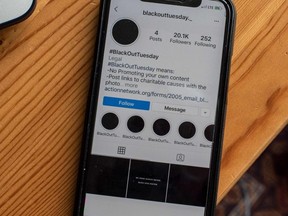 A smartphone displaying the Instagram #blackouttuesday account is seen in Washington on June 2, 2020.