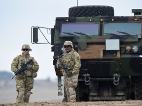 In this file photo taken on March 04, 2020, US soldiers patrol prior to an artillery live fire event by the US Army Europe's 41st Field Artillery Brigade at the military training area in Grafenwoehr, Germany.