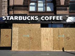 A Starbucks coffee store is seen boarded up on June 8, 2020 after rampant open looting and vandalism in New York, following the Minneapolis police killing of George Floyd.