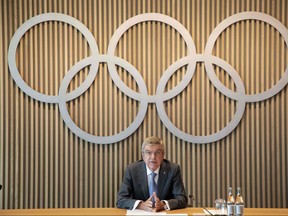 This handout picture released by International Olympic Committee (IOC) on June 10, 2020 shows IOC president Thomas Bach holding a press conference under the Olympic rings following a executive board meeting at the IOC's headquarters in Lausanne.