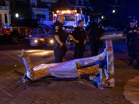 A statue of Confederate States President Jefferson Davis lies on the street after protesters pulled it down in Richmond, Virginia, on June 10, 2020.