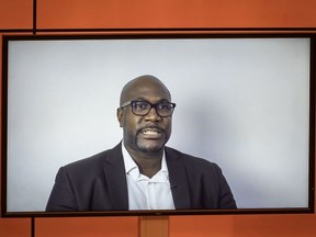 A TV screen shows George Floyd's brother, Philonise Floyd speaking via video message during an urgent debate on "systemic racism" in the United States and beyond at the Human Rights Council on June 17, 2020 in Geneva.