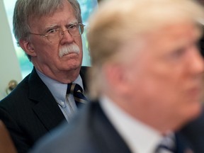 In this file photo U.S. President Donald Trump speaks alongside National Security Adviser John Bolton, left, during a cabinet meeting in the Cabinet Room of the White House in Washington, DC, May 9, 2018.