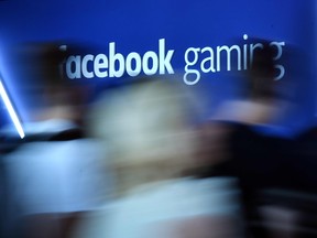 In this file photo taken on August 21, 2019 visitors walk past the "Facebook Gaming" stand at the video games trade fair Gamescom in Cologne, western Germany.