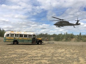 An Alaska National Guard helicopter hovers near "Bus 142" after it was deposted on the ground west of Healy, Alaska, June 18, 2020.
