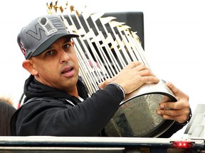 Boston Red Sox Manager Alex Cora holds the World Series trophy during the team's victory parade on October 31, 2018 in Boston.