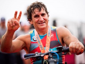 Former Formula One driver and paracyclist Alex Zanardi poses after finishing IRONMAN Barcelona on September 30, 2017 in Calella, Spain.