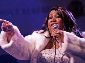 In this Nov. 6, 2007 file photo, Aretha Franklin performs outside Holt Renfrew in Toronto as part of the store's unveiling of their holiday theme's windows.