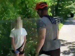 A cyclist is seen in a video posted on Twitter confronting a young girl who was posting flyers protesting racial injustice on a nature trail outside Washington.