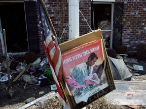 A movie poster for "Gone with the Wind" sits in a front yard of a home damaged by Hurricane Katrina in Chalmette, Louisiana, in St. Bernard Parish September 28, 2005.