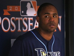Carl Crawford the Tampa Bay Rays waits in the dugout during Game 2 of the ALDS against the Texas Rangers at Tropicana Field on October 7, 2010 in St. Petersburg, Florida.