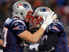 New England Patriots quarterback Tom Brady (right) celebrates with teammate Rob Gronkowski in Foxborough, Massachusetts, January 14, 2012.