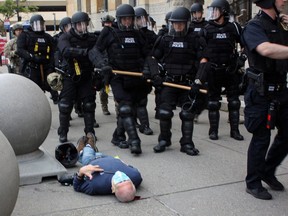 Martin Gugino, a 75-year-old protester, lays on the ground after he was shoved by two Buffalo police officers during a protest in Niagara Square in Buffalo June 4, 2020.