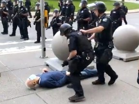 In this still image courtesy of National Public Radio (NPR) television station WBFO and taken by Mike Desmond, a 75-year-old protester falls to the ground after being shoved by Buffalo police, on June 4, 2020.