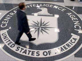 In this file photo taken on August 13, 2008 a man walks over the seal of the Central Intelligence Agency (CIA) in the lobby of CIA Headquarters in Langley, Virginia.