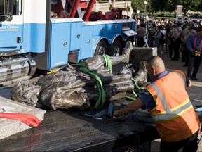 A statue of Christopher Columbus, which was toppled to the ground by protesters, is loaded onto a truck on the grounds of the State Capitol on June 10, 2020 in St Paul, Minnesota.