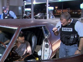 This TV publicity image released by Fox shows police officers in Hillsborough, Fla., interrogating two occupants of a car for suspicious drug activity.