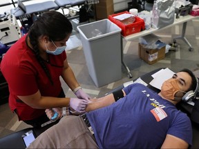 Mario Cecchetti, 27, donates blood amid the coronavirus outbreak in Los Angeles June 16, 2020.