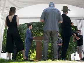 Reoprters listen to Prime Minister Justin Trudeau as he responds to a question during a news conference outside Rideau Cottage in Ottawa, Monday, June 22, 2020.
