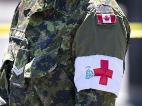 The armband of a military care giver is seen during a ceremony marking the last day of military presence at the CHSLD Nazaire-Piche in Montreal, on Wednesday, June 17, 2020.
