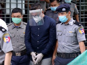 Canadian Christian pastor David Lah (centre) is escorted for his trial at Mayangone Township Court in Yangon, Myanmar, Wednesday, June 3, 2020.