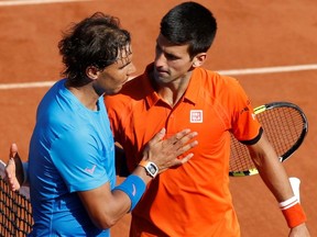 Novak Djokovic hugs Rafa Nadal following his victory in the 2015 French Open quarterfinals at Roland Garros in Paris.
