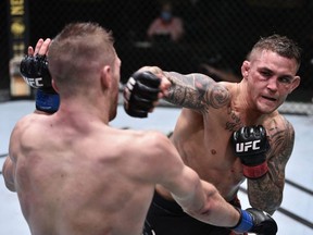 Dustin Poirier (red gloves) punches Dan Hooker (blue gloves) during UFC Fight Night at the UFC APEX in Las Vegas, Saturday, June 27, 2020.