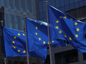 European Union flags flutter outside the European Commission headquarters in Brussels, June 25, 2020.
