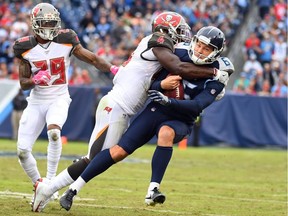 Tennessee Titans punter Brett Kern (6) is tackled by Tampa Bay Buccaneers linebacker Devin White (45) on a fake field goal attempt during the second half at Nissan Stadium.