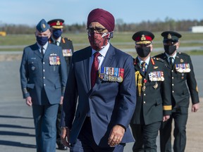 Defence Minister Harjit Sajjan is followed by Canadian Forces officers at the homecoming ceremony for RCAF Capt. Jennifer Casey at Halifax Stanfield International Airport in Enfield, N.S. on Sunday, May 24, 2020.