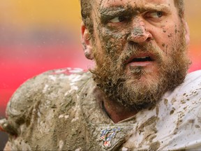 Covered in mud, offensive guard Mike Person of the San Francisco 49ers looks on after making a tackle on defensive back Troy Apke of the Washington Redskins (not pictured) during the third quarter at FedExField on October 20, 2019 in Landover, Maryland.