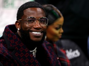 Rapper Gucci Mane smiles court side before the game between the Boston Celtics and the Brooklyn Nets at TD Garden on Nov. 27, 2019 in Boston, Massachusetts.