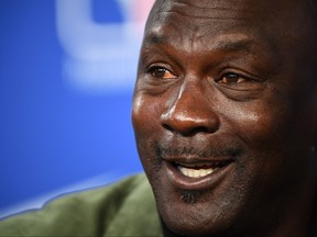 Former NBA star and owner of Charlotte Hornets team Michael Jordan gestures as he addresses a press conference ahead of the NBA basketball match between Milwaukee Bucks and Charlotte Hornets at The AccorHotels Arena in Paris on Jan. 24, 2020.