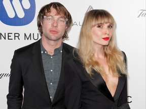 US musicians Mickey Madden of Maroon 5 and Z Berg pose as they arrive to attend the Warner Music After Party, in Hollywood, California, on February 16, 2016.