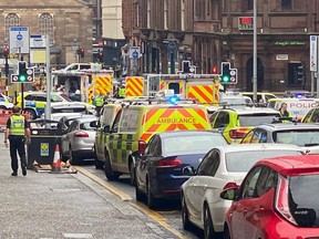 Emergency responders are seen near a scene of reported stabbings, in Glasgow, Scotland, Friday, June 26, 2020, in this picture obtained from social media.