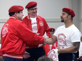 New Guardian Angel Nathan Yusep (right) is congratulated by Chapter Leader Dave Schroeder (centre) and founder Curtis Sliwa (left) during a graduation ceremony of local Guardian Angels. Sliwa is in the news now for defending stores from looters in New York City