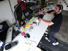 Belgian Yves Hanoulle, IT professional, walks on a treadmill installed under his desk, with the average of 20km daily, as he works in his home in Ghent, Belgium June 11, 2020.