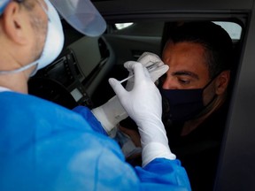Michael Salzhauer, a plastic surgeon known as Dr. Miami, applies Botox to a patient while conducting drive-through Botox injections in the garage of his clinic, as Miami-Dade County eases some of the lockdown measures put in place during the coronavirus disease (COVID-19) outbreak, in Miami, Florida, U.S., May 31, 2020.