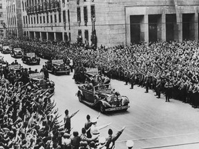 Crowds salute German Nazi leader Adolf Hitler on his arrival in Berlin from Munich, October 2, 1938.