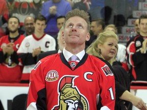 Former Ottawa Senators player Daniel Alfredsson watches as a banner with his retired jersey number 11, is raised to the rafters in Ottawa, Thursday December 29, 2016.