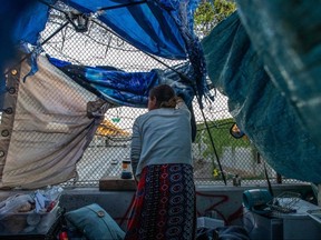 Nicole (last name not given) watches the traffic from inside her tent over the bridge in Los Angeles on May 25, 2020.