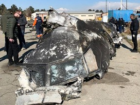 This file photo taken on Jan. 11, 2020 shows people analyzing the remains of the Ukraine International Airlines plane that crashed outside Tehran on Jan. 8, 2020.