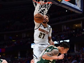 Nuggets guard Jamal Murray (27) finishes off a basket over Bucks forward D.J. Wilson (5) in the third quarter at the Pepsi Center, in Denver, March 9, 2020.