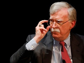 Former U.S. national security adviser John Bolton adjusts his glasses during his lecture at Duke University in Durham, North Carolina, February 17, 2020.