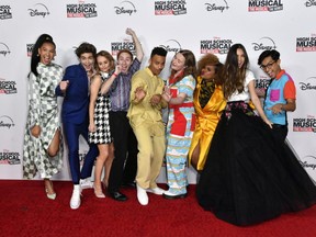 Joshua Bassett, second from left, is seen posing for photos with the cast of Disney+'s "High School Musical" at Walt Disney Studio Lot in Burbank, Calif., Nov. 1, 2019.