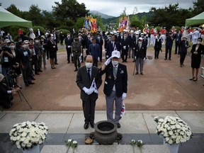Korean War veterans salute before a monument during a ceremony marking the 70th anniversary of the start of the Korean War at the Baengmagoji War Memorial in Cheorwon, near the Demilitarized Zone separating North and South Korea.