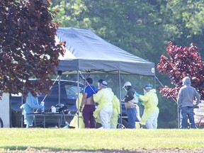 Migrant workers are tested for the COVID-19 virus Monday by a team of medical professionals at ScotLynn Group, a farm operation that produces corn, watermelon, asparagus and pumpkins in Vittoria, Ont.